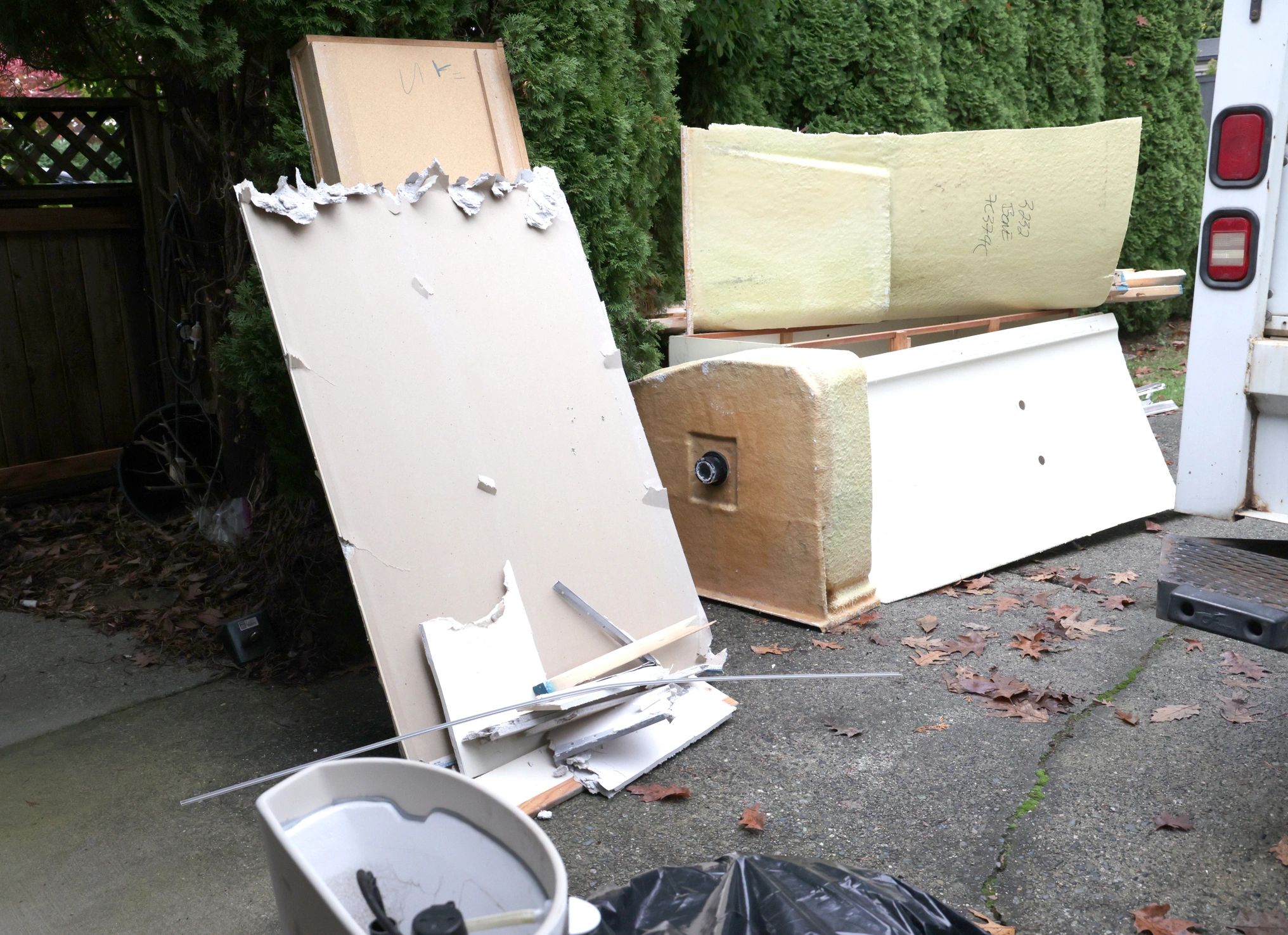 Remodel debris staged on a driveway for haul-away