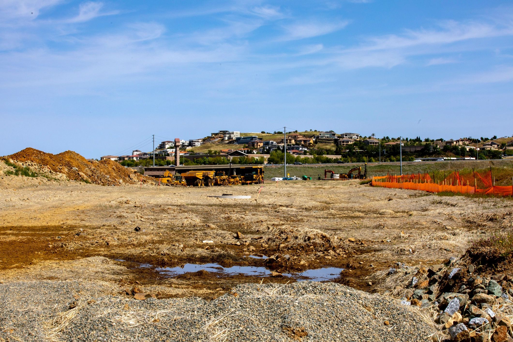 Dump trucks and earthmoving activity at a development site
